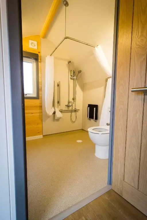 a bathroom with a toilet and a shower at Evelix Pods Dornoch in Dornoch