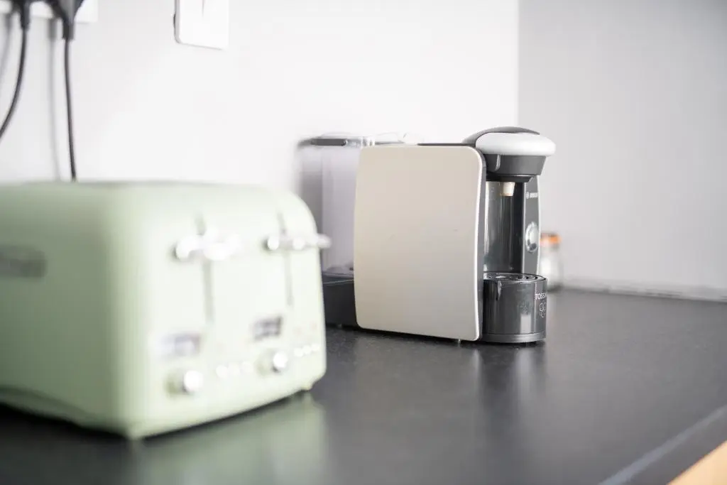 a counter top with a coffee maker and a toaster at Dryburgh Apartments No2 in Inverness