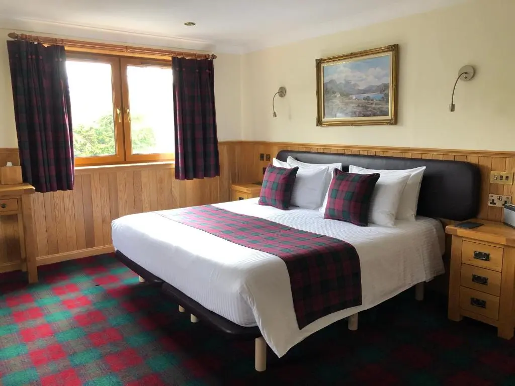 a bedroom with a large bed in a room at Binnilidh Mhor B&B in Glenmoriston