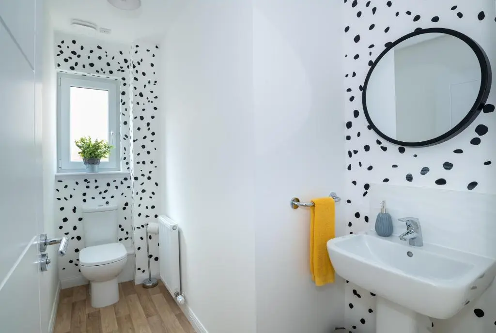 a bathroom with a white toilet and a mirror at Lily Bank House in Inverness