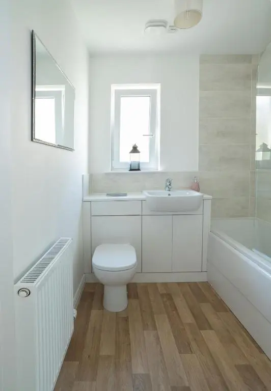 a bathroom with a toilet and a sink and a tub at Lily Bank House in Inverness