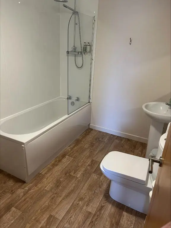 a bathroom with a shower and a toilet and a sink at Whisky Capital Inn in Dufftown