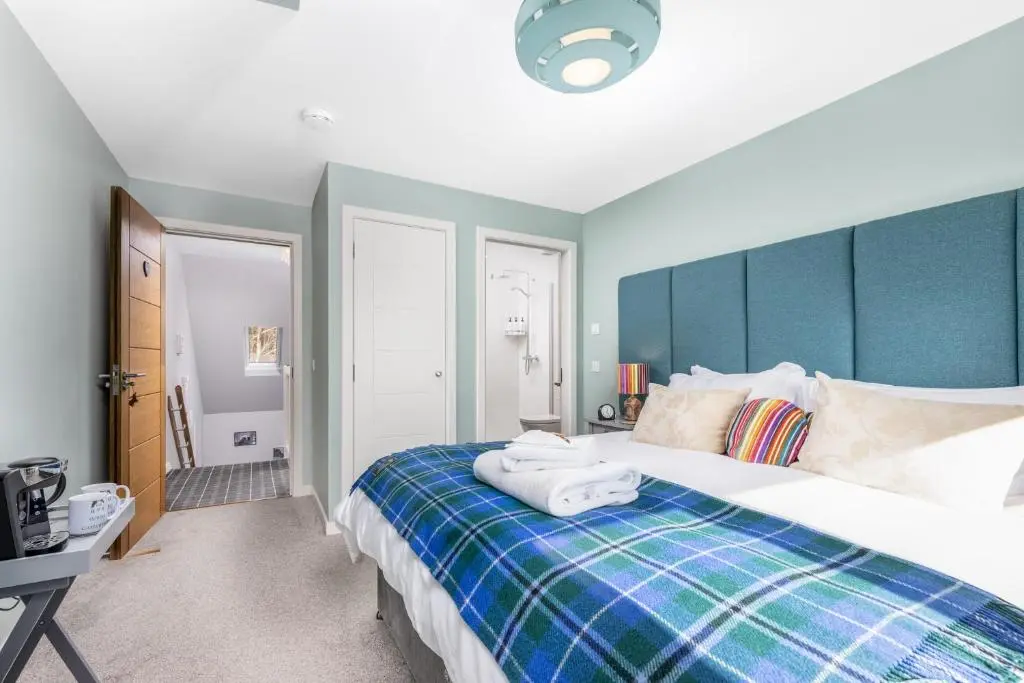 a bedroom with a bed with towels on it at Heartseed House Bed & Breakfast in Dornoch