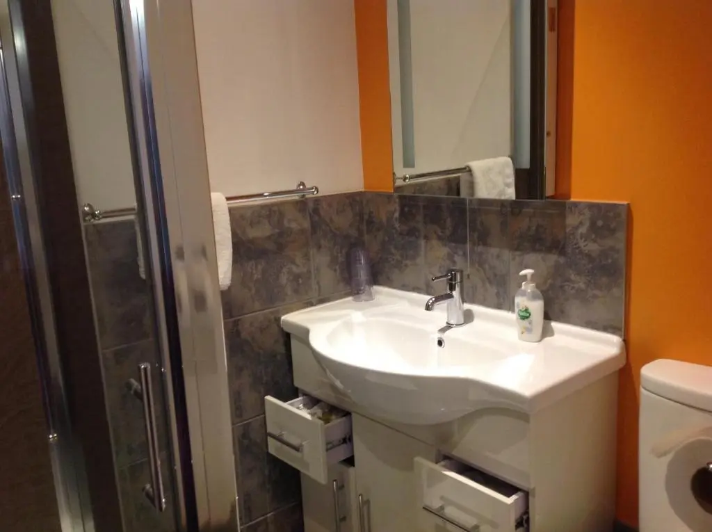 a bathroom with a sink and a shower at Dunroamin Bed and Breakfast in Aviemore