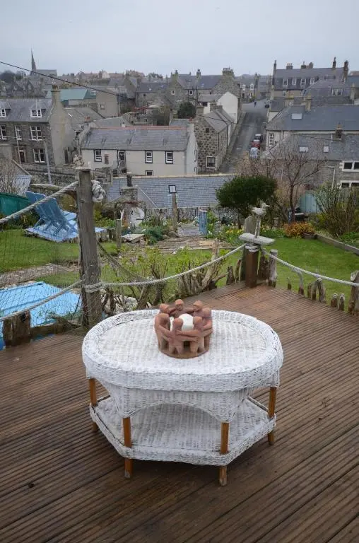 a bowl on top of a table on a deck at Driftwood Cottage, Portsoy in Banff