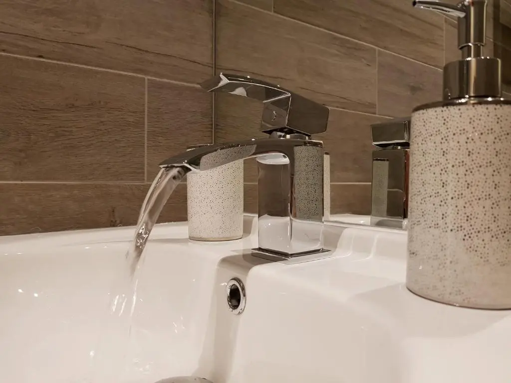 a bathroom sink with a water faucet at Smart & Cozy Holiday Apartment in the city centre in Inverness