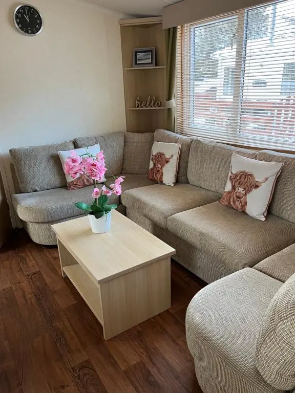 a living room with two couches and a coffee table at Braemar in Dornoch