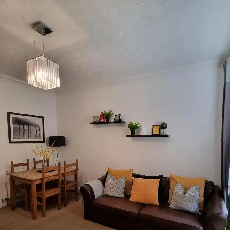 a living room with a couch and a table at Inverness City Centre Flat in Inverness