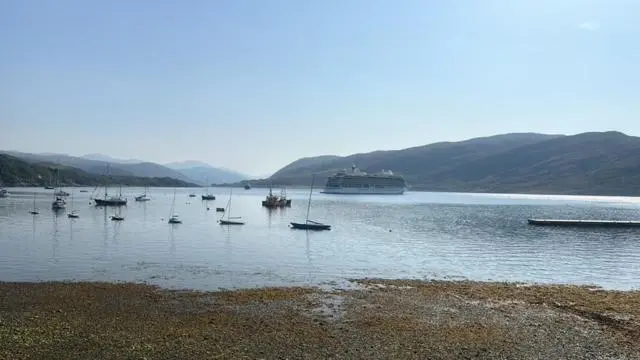 a group of boats sitting in a large body of water at Argyll Hotel in Ullapool