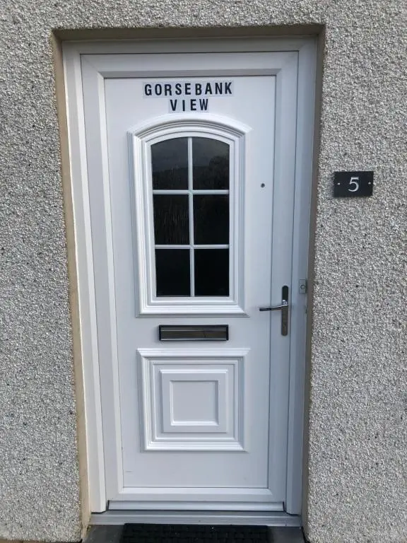 a white garage door with a window on it at Gorsebank View in Inverness