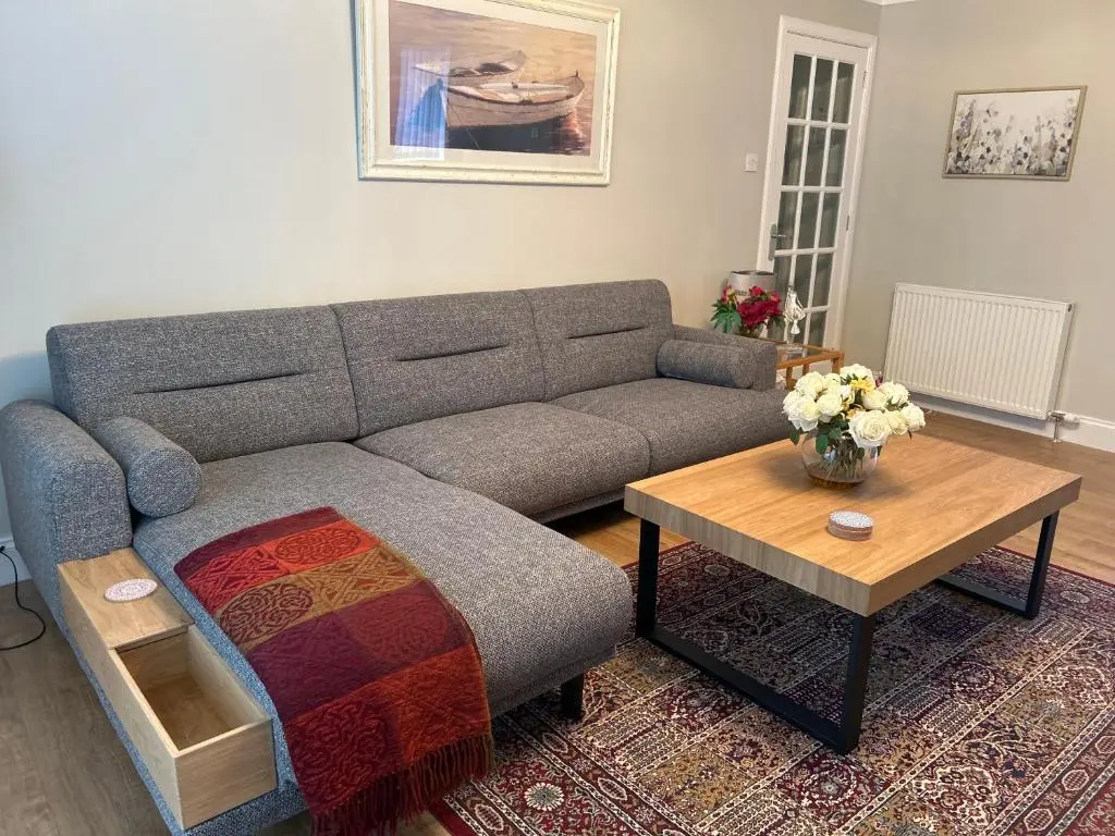 a living room with a couch and a coffee table at The Maples 26 Wellingtonia Court in Inverness