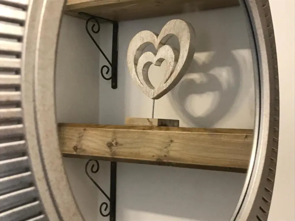 a mirror with a heart on a shelf at The King Street Holiday Apartment in Inverness City Centre in Inverness