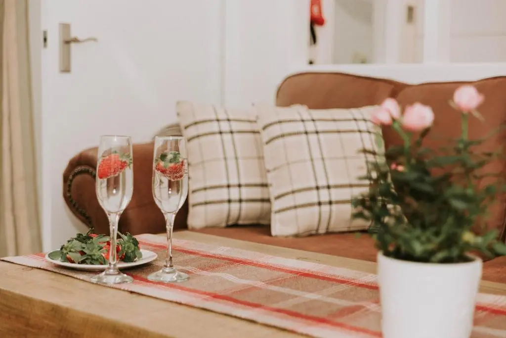 a table with two wine glasses and a plate of food at The King Street Holiday Apartment in Inverness City Centre in Inverness