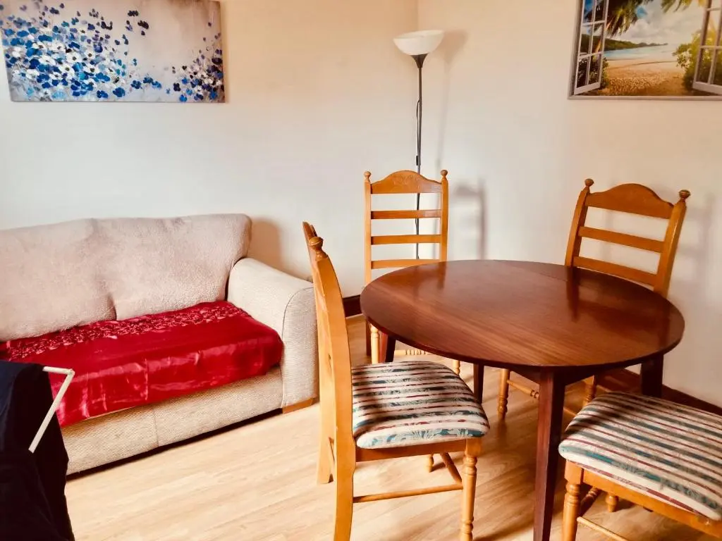 a living room with a table and a couch at Inverken House in Inverness