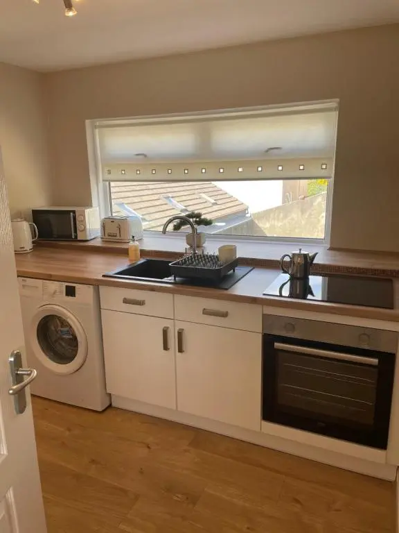 a kitchen with a sink and a window at The Jewel of the Moray Firth in Lossiemouth
