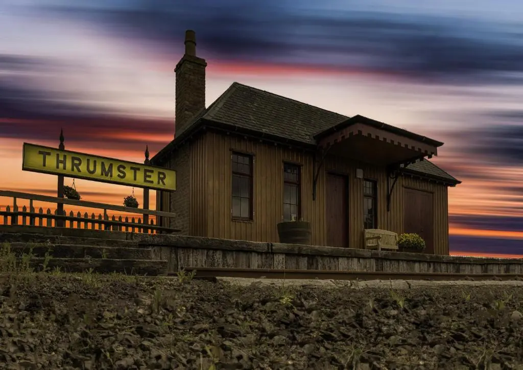 a house with a sign in front of it at Greenfield Cottage in Thrumster