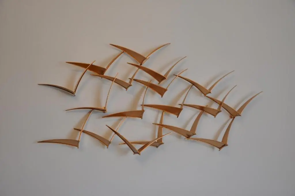 a metal sculpture of a plant on a white background at Emahroo Cullen in Cullen