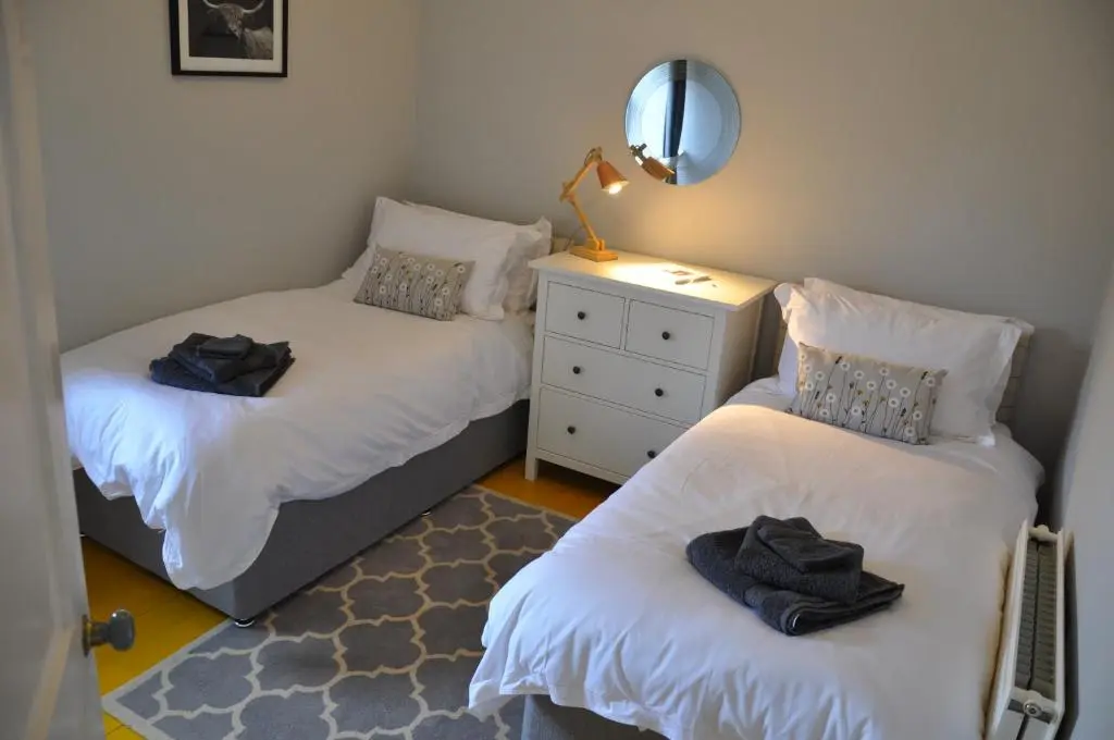 a bedroom with two twin beds and a mirror at Emahroo Cullen in Cullen
