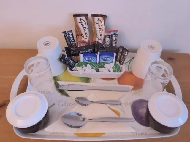 a tray with toilet paper and utensils on a table at Dacama House Accommodation in Ullapool