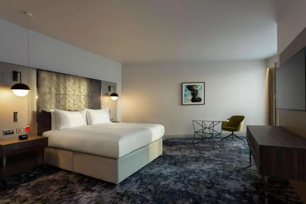 a hotel room with a bed and a desk at Hilton Aberdeen TECA in Aberdeen