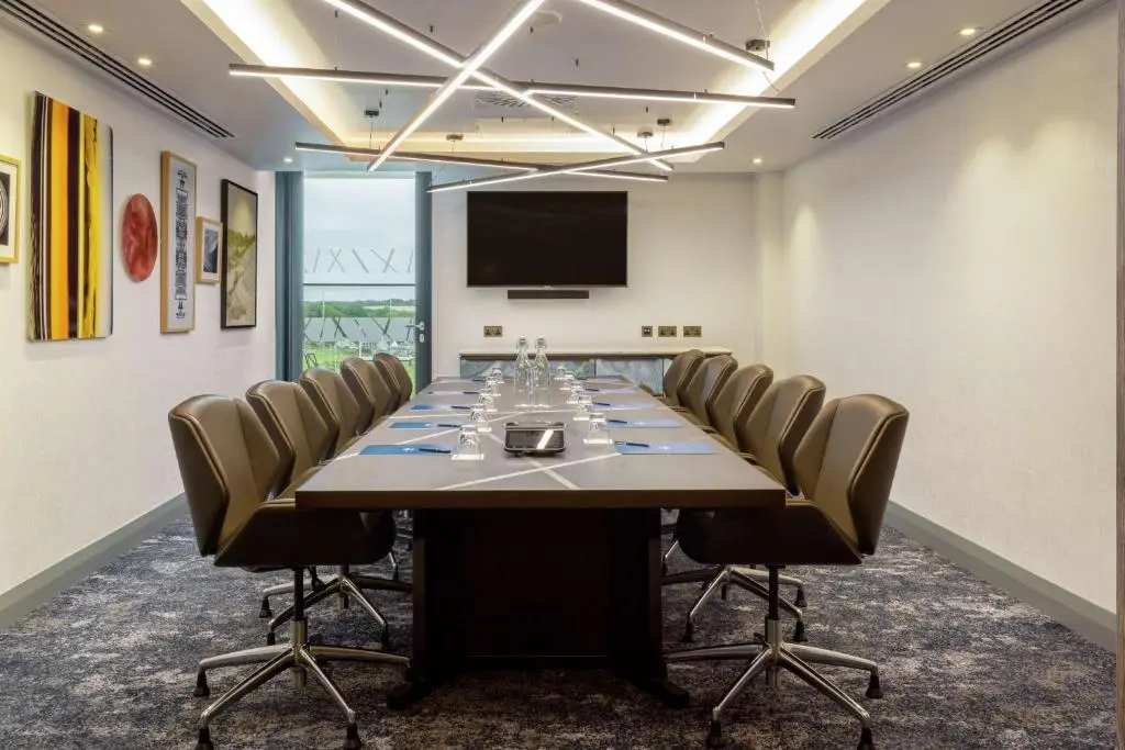 a conference room with a large table and chairs at Hilton Aberdeen TECA in Aberdeen