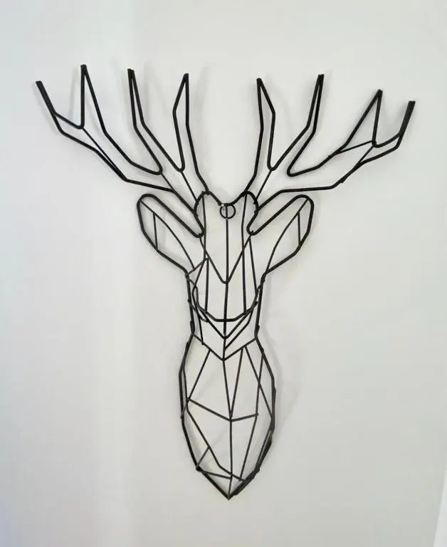a black reindeer head hanging on a wall at Wellingtonia Court Apartment in Inverness