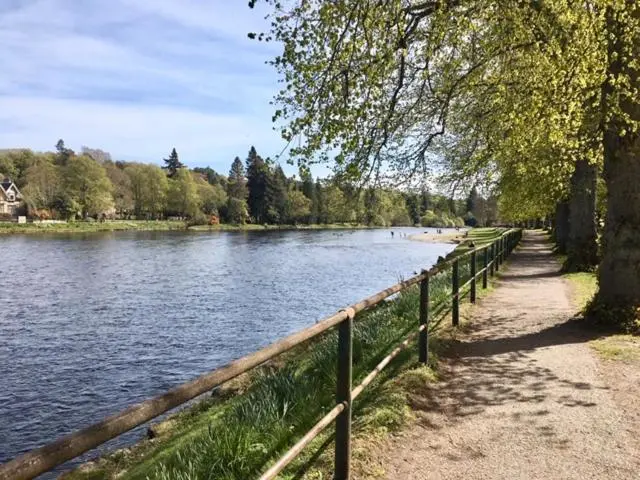a path next to a river with a fence at Wellingtonia Court Apartment in Inverness