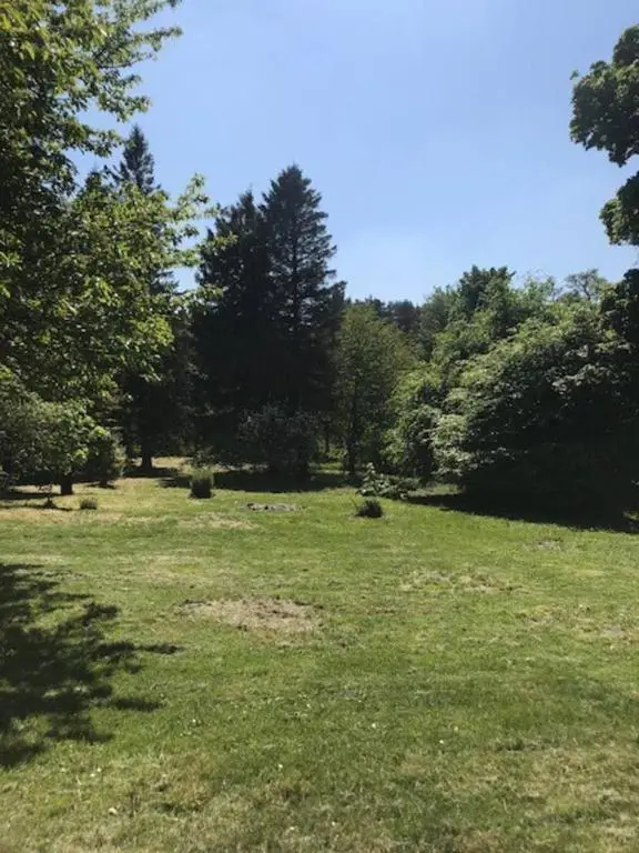 a field of green grass with trees in the background at Traditional Family Home in Royal Deeside in Aboyne