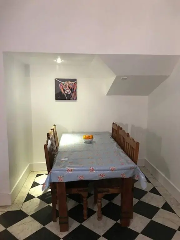 a dining room with a table and chairs at Traditional Family Home in Royal Deeside in Aboyne