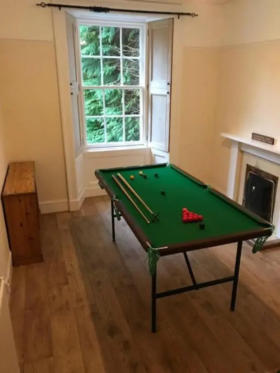 a green pool table in a room with a fireplace at Traditional Family Home in Royal Deeside in Aboyne