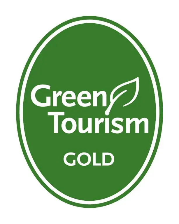 a green tournament gold sign in a green circle at Garden Park Guest House in Grantown on Spey