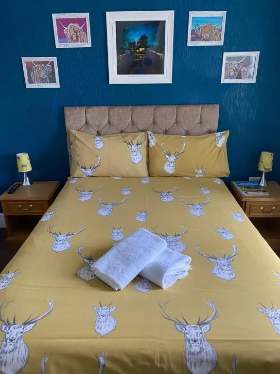 a bedroom with a bed with deer heads on it at No 29 Bed and Breakfast in Inverness
