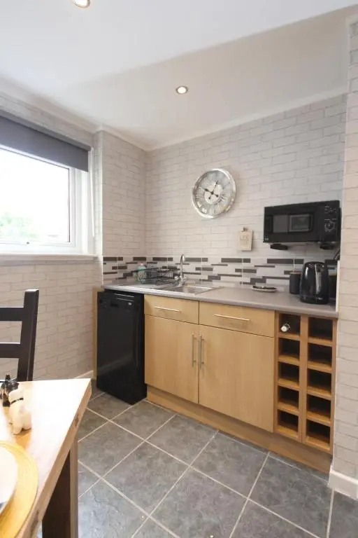a kitchen with a sink and a stove top oven at Arrandale in Inverness