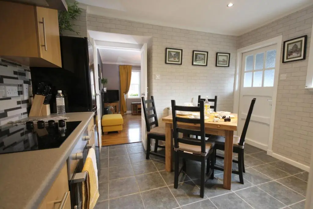 a kitchen and dining room with a table and chairs at Arrandale in Inverness