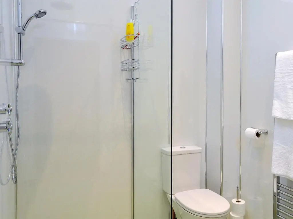 a bathroom with a toilet and a shower at The Old Inverchroskie Kennels in Enochdhu