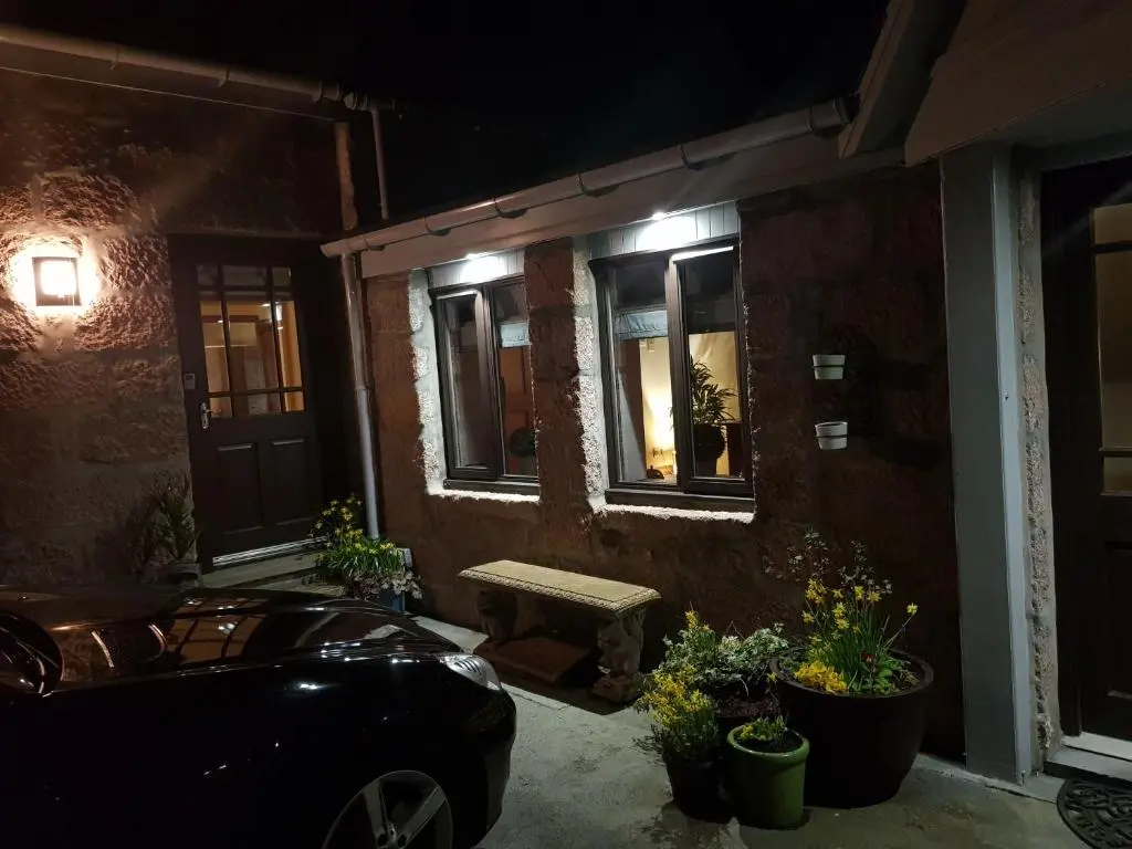 a car parked outside of a building at night at The Smiddy Suite in Ellon