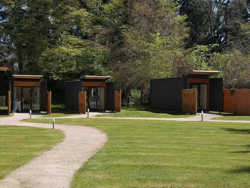 a row of tiny homes in a park at A UNIQUE Experience in a Converted Shipping Containers, Glamness is Adults Only in Inverness