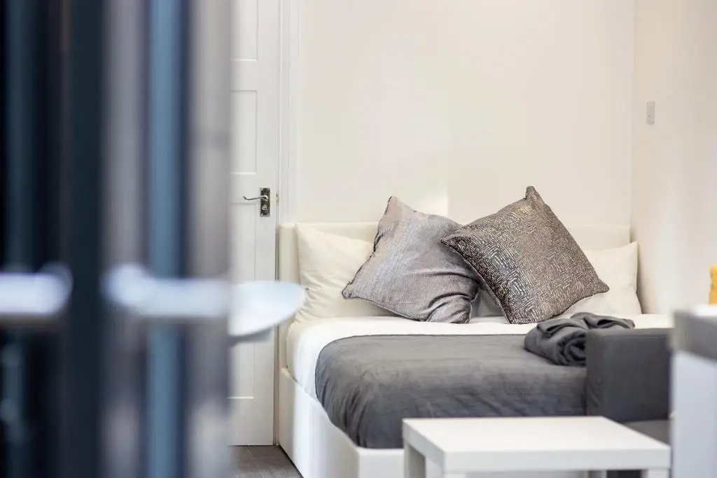 a bed with pillows on it in a room at A UNIQUE Experience in a Converted Shipping Containers, Glamness is Adults Only in Inverness