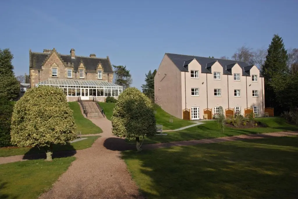 a large house with a pathway in front of it at Inverness Lochardil House, by Highland Coast Hotels in Inverness