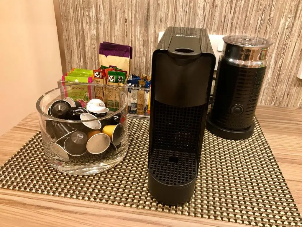 a black blender sitting on a table with a bowl of rocks at exploreNESS Apartment in Inverness