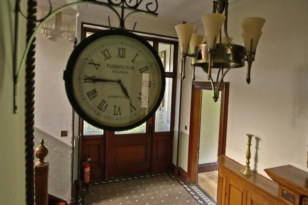 a large clock hanging on the wall in a hallway at Isla Bank House in Keith