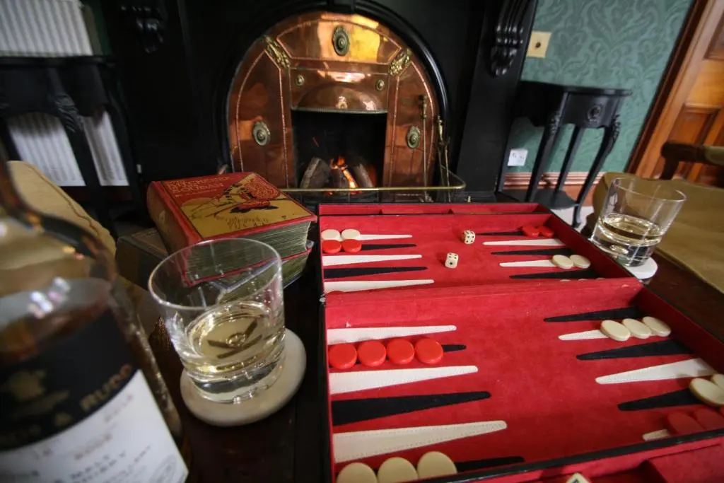 a table with a display of wine bottles and pills at Isla Bank House in Keith