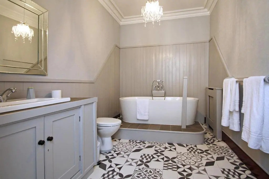 a bathroom with a tub and a toilet and a sink at Isla Bank House in Keith