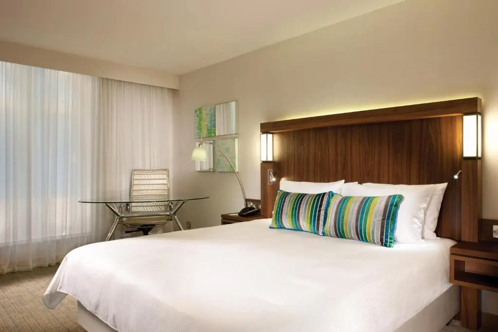 a large white bed in a hotel room at Courtyard by Marriott Aberdeen Airport in Dyce