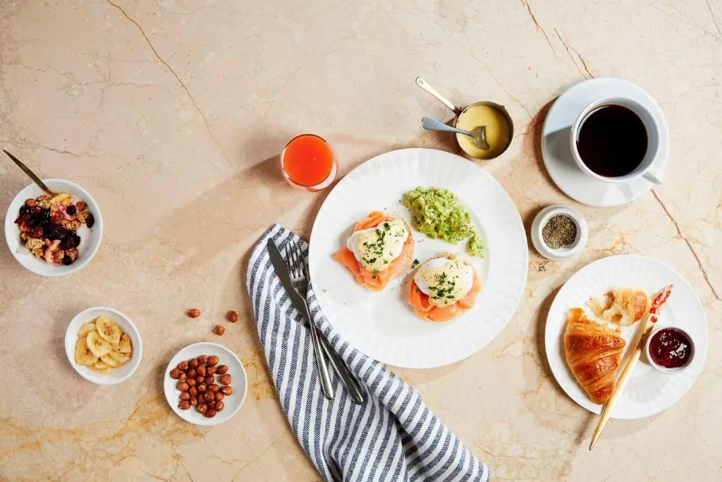 a table with plates of food and a cup of coffee at Courtyard by Marriott Aberdeen Airport in Dyce