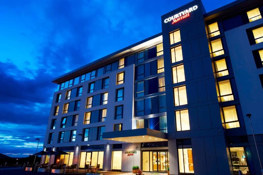 an office building with lights on at night at Courtyard by Marriott Aberdeen Airport in Dyce