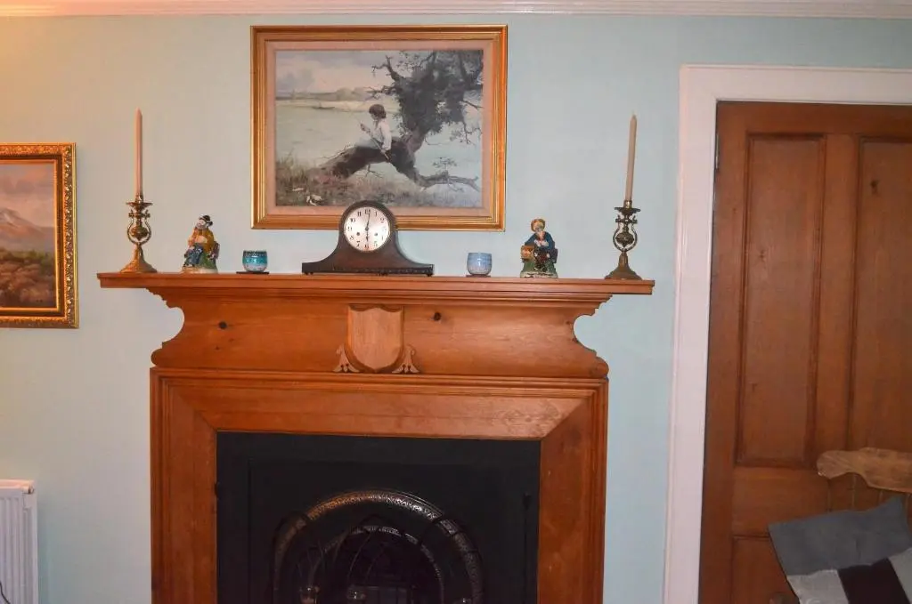 a fireplace with a clock on top of it at The Quaich B&B in Inverness