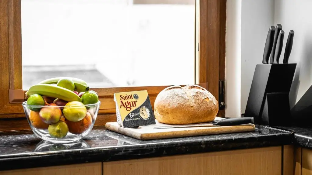 a bowl of fruit and a loaf of bread on a counter at Aldo's Place in Dingwall