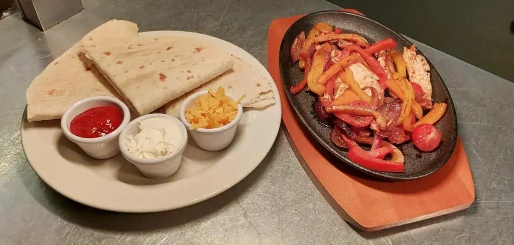 a plate of food with bread and vegetables and dips at Gordon Arms Hotel in Fochabers