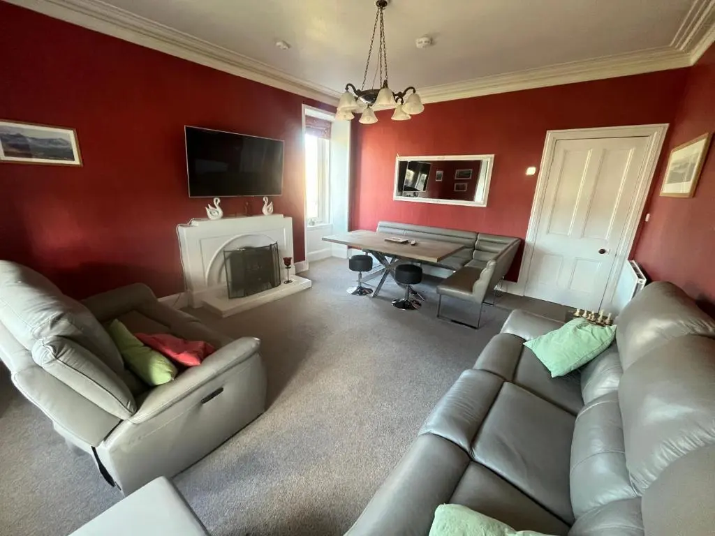 a living room with a couch and a table at Period House / Entire Upstairs Flat in Inverness
